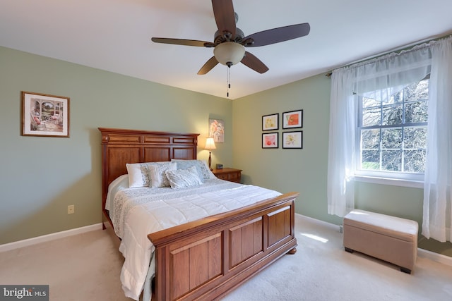 bedroom featuring baseboards, a ceiling fan, and light carpet