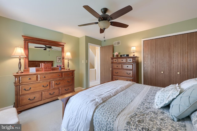 carpeted bedroom featuring baseboards, ceiling fan, a closet, and visible vents