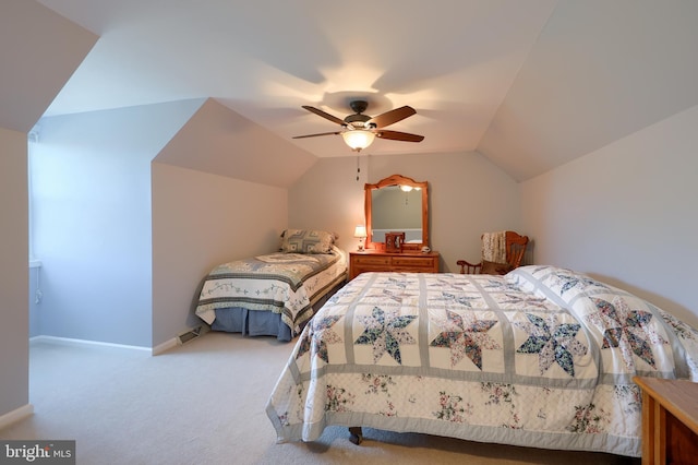 carpeted bedroom with baseboards, a ceiling fan, lofted ceiling, and visible vents