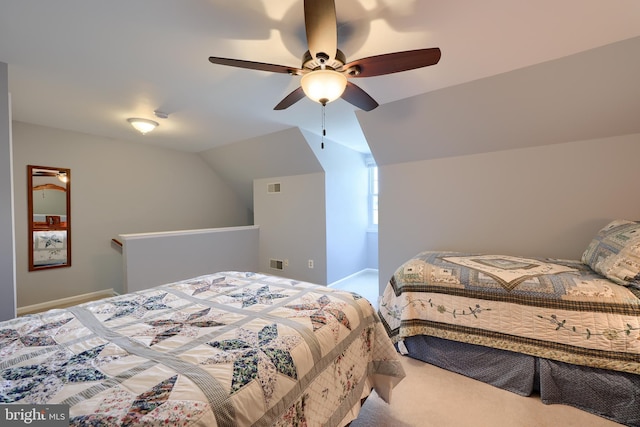 carpeted bedroom with visible vents, a ceiling fan, baseboards, and vaulted ceiling