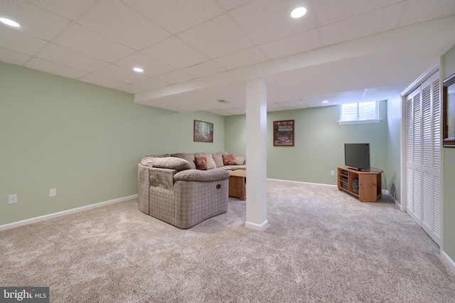carpeted living area featuring recessed lighting, baseboards, and a drop ceiling