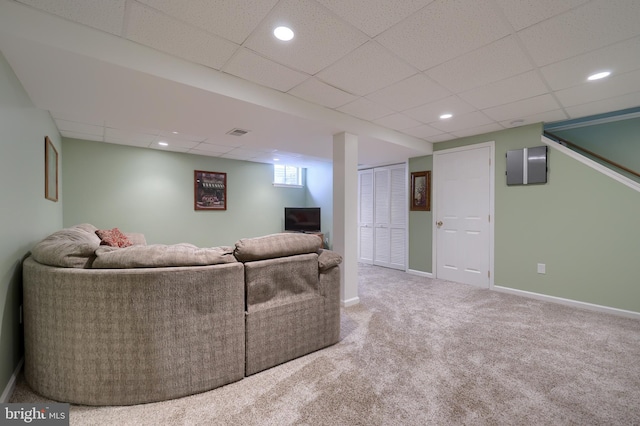carpeted living area featuring recessed lighting, baseboards, visible vents, and a drop ceiling