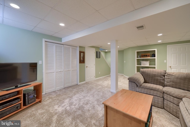 living area with carpet, recessed lighting, baseboards, a drop ceiling, and visible vents