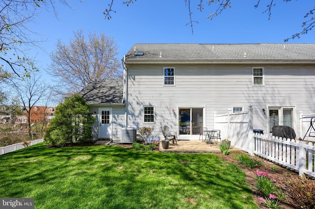 rear view of house featuring a yard, fence, cooling unit, and a patio area