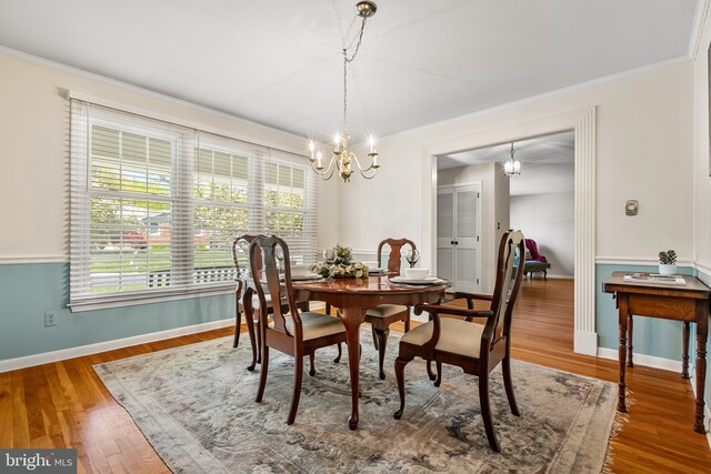 dining room with baseboards, a notable chandelier, and ornamental molding