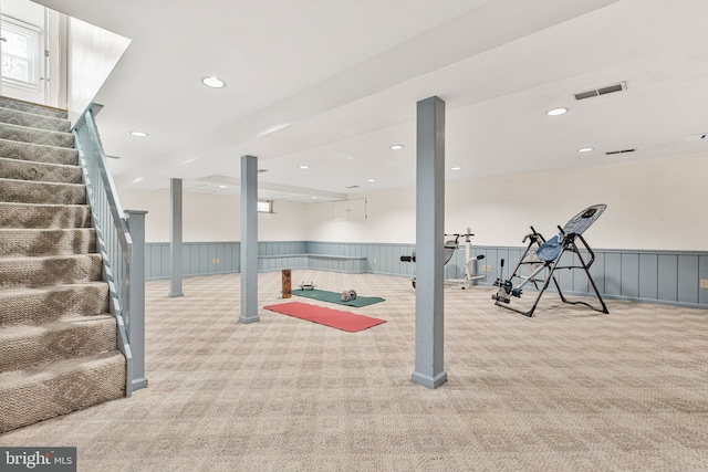 interior space with carpet floors, a wainscoted wall, recessed lighting, and visible vents