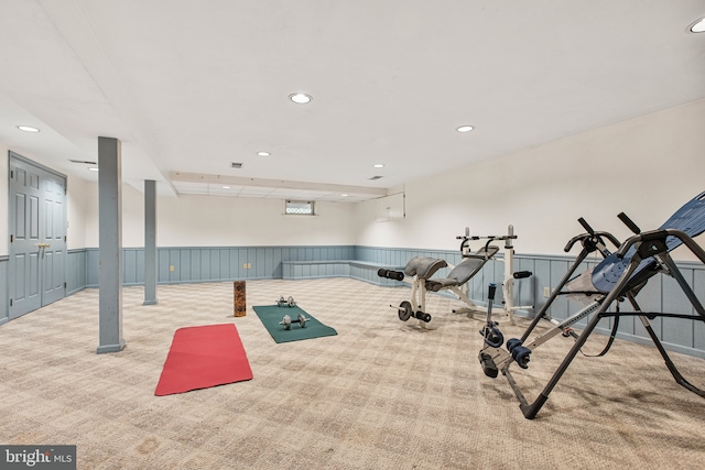 workout room with a wainscoted wall, carpet, and recessed lighting