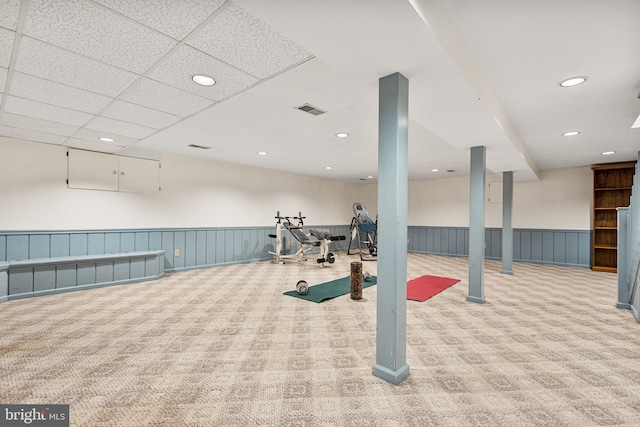 exercise room with visible vents, carpet flooring, wainscoting, and recessed lighting