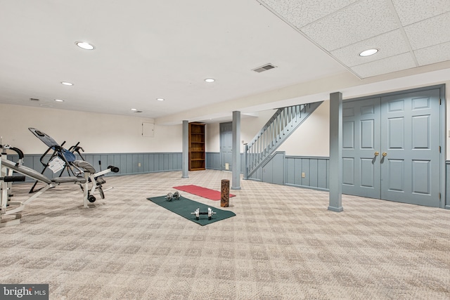 workout area featuring carpet floors, recessed lighting, wainscoting, and visible vents