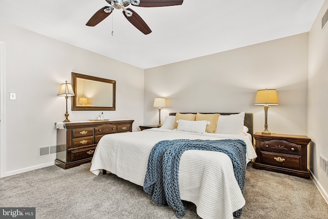 carpeted bedroom featuring baseboards, visible vents, and ceiling fan