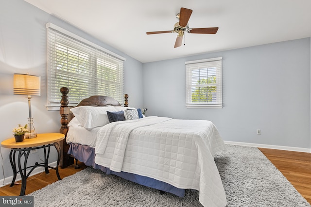 bedroom featuring baseboards, a ceiling fan, and wood finished floors