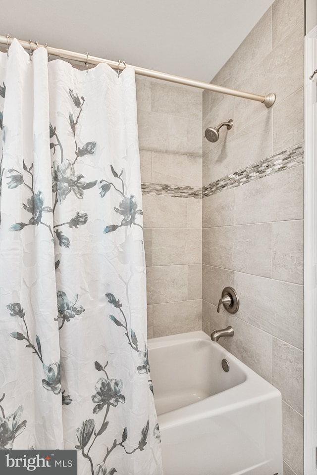 bathroom featuring shower / bathtub combination with curtain