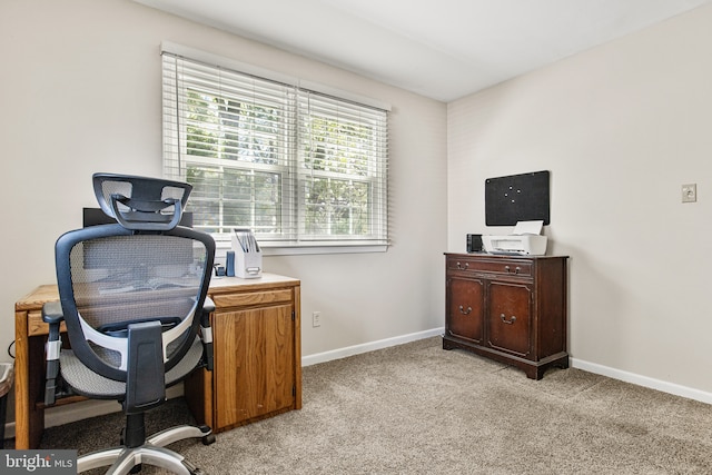home office featuring baseboards and light colored carpet