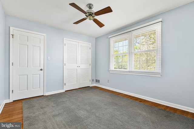 unfurnished bedroom featuring baseboards, ceiling fan, a closet, and visible vents
