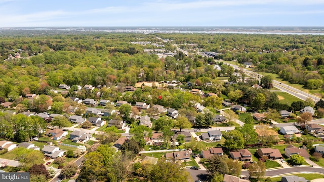 birds eye view of property with a residential view and a wooded view