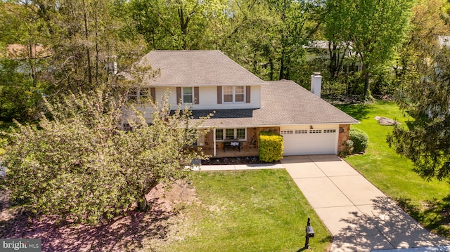 view of front of home featuring roof with shingles, an attached garage, a front lawn, a chimney, and concrete driveway