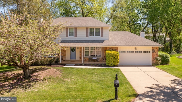 traditional-style house with an attached garage, a front yard, stone siding, a porch, and driveway