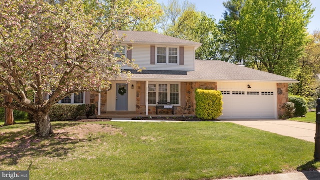 traditional-style home with covered porch, concrete driveway, stone siding, and a garage