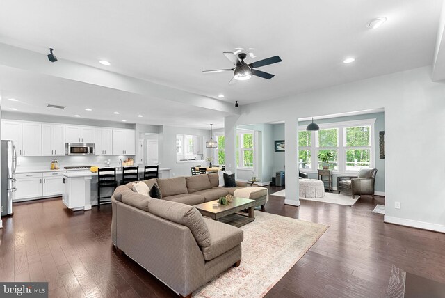 living room with recessed lighting, ceiling fan, dark wood-style flooring, and visible vents