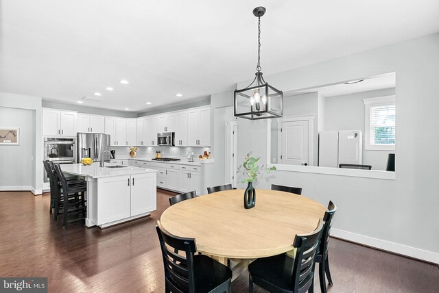 dining area with recessed lighting, baseboards, a chandelier, and dark wood-type flooring