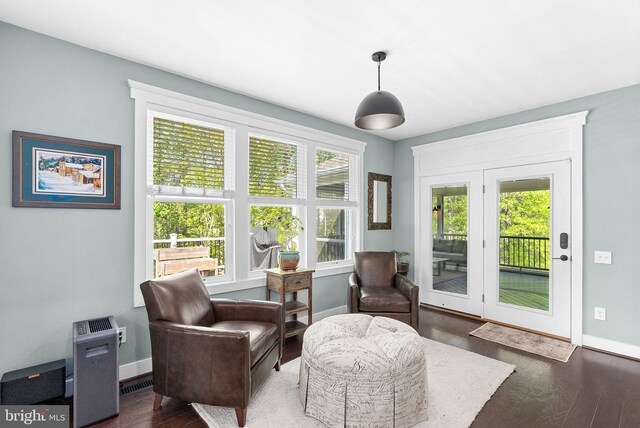 sitting room featuring baseboards and wood finished floors
