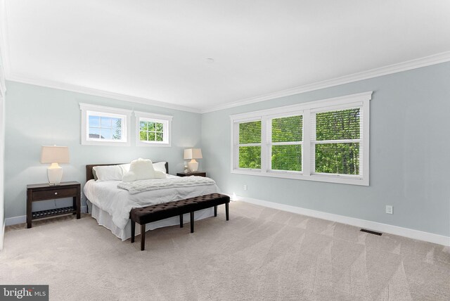 bedroom featuring visible vents, crown molding, and multiple windows