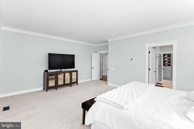 bedroom with crown molding, baseboards, and light carpet