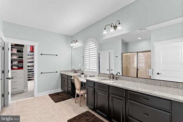 full bath with visible vents, a sink, two vanities, and tile patterned floors