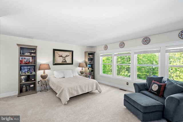 bedroom featuring baseboards, carpet floors, and visible vents