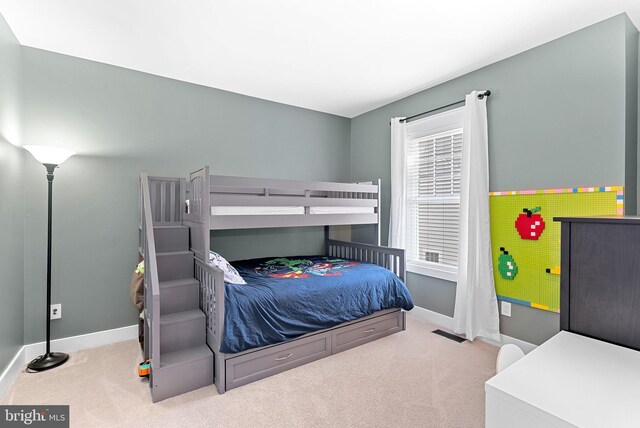 carpeted bedroom featuring baseboards