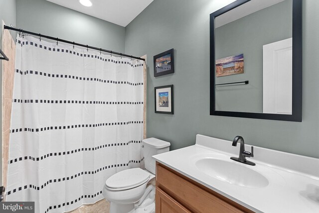 bathroom with vanity, toilet, and a shower with curtain