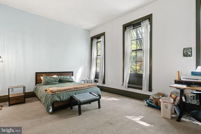 carpeted bedroom featuring baseboards
