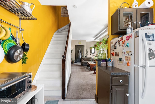 staircase with a toaster and carpet floors