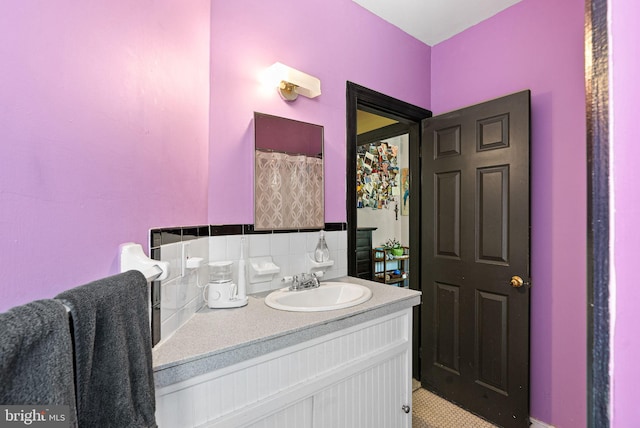 full bathroom featuring vanity and tasteful backsplash