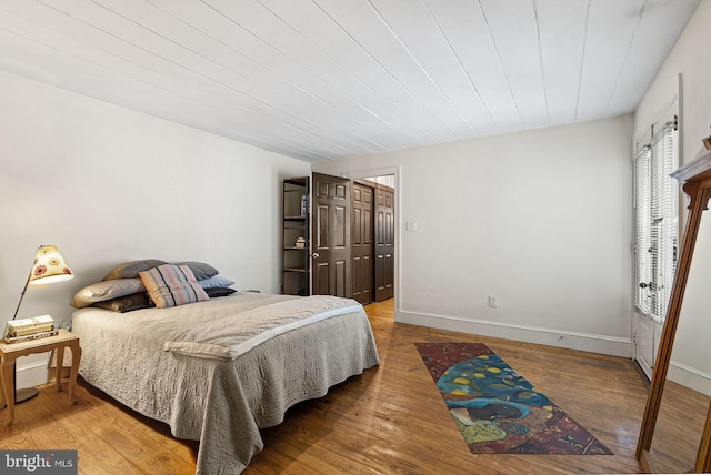 bedroom featuring baseboards and wood finished floors