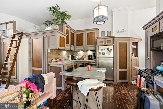 kitchen featuring appliances with stainless steel finishes, light countertops, decorative backsplash, dark wood-type flooring, and glass insert cabinets