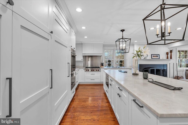 36 E Oak Ave, Moorestown, NJ 08057 - kitchen with recessed lighting, white cabinets, a chandelier, and stainless steel gas stovetop