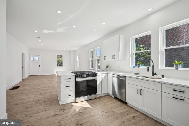 kitchen with gas range, recessed lighting, a sink, dishwasher, and a wealth of natural light