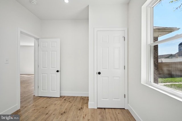 unfurnished bedroom with recessed lighting, baseboards, and light wood finished floors
