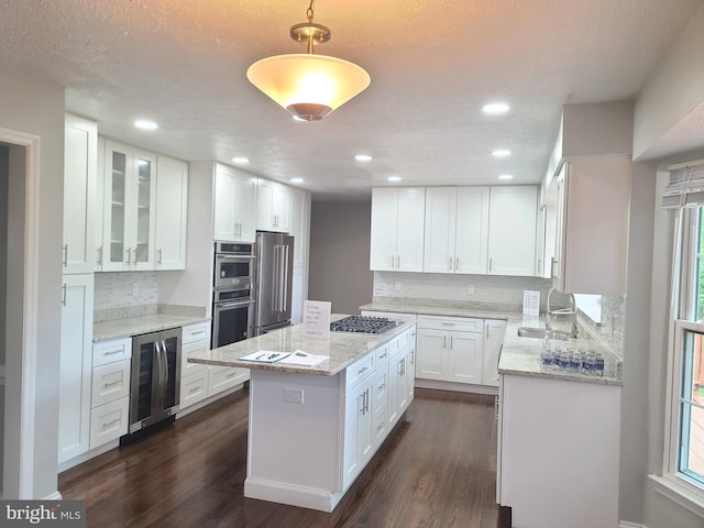 303 Saybrooke View Dr, Gaithersburg, MD 20877 - kitchen with wine cooler, appliances with stainless steel finishes, dark wood-style floors, a center island, and recessed lighting