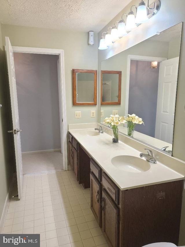 303 Saybrooke View Dr, Gaithersburg, MD 20877 - bathroom with double vanity, a textured ceiling, and tile patterned floors