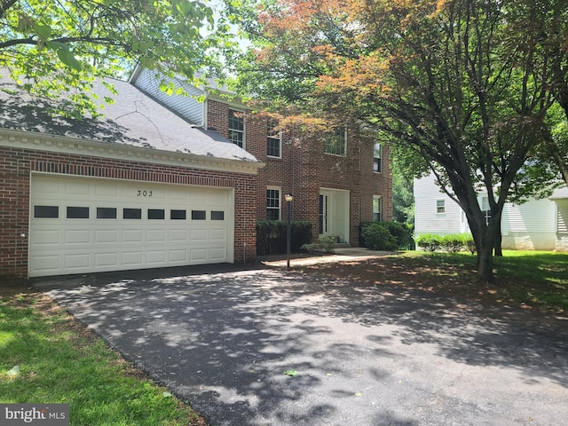 303 Saybrooke View Dr, Gaithersburg, MD 20877 - view of front of home featuring asphalt driveway, brick siding, and an attached garage