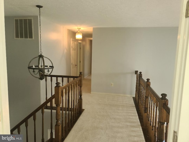 303 Saybrooke View Dr, Gaithersburg, MD 20877 - hall featuring an upstairs landing, a chandelier, carpet, and a textured ceiling