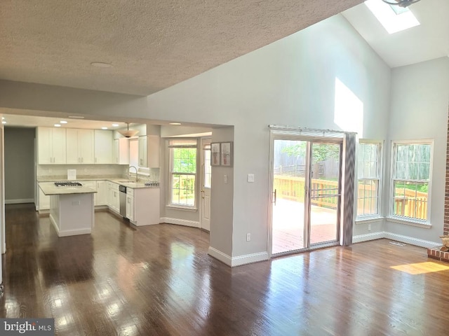303 Saybrooke View Dr, Gaithersburg, MD 20877 - kitchen with appliances with stainless steel finishes, a skylight, light countertops, white cabinetry, and dark wood-style floors