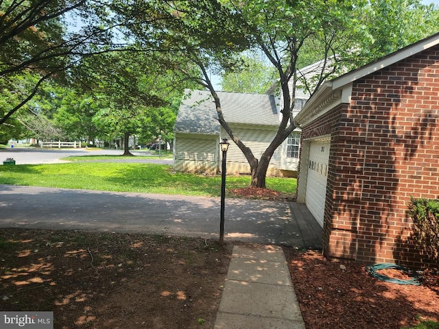 303 Saybrooke View Dr, Gaithersburg, MD 20877 - view of side of property with brick siding, a garage, and a yard