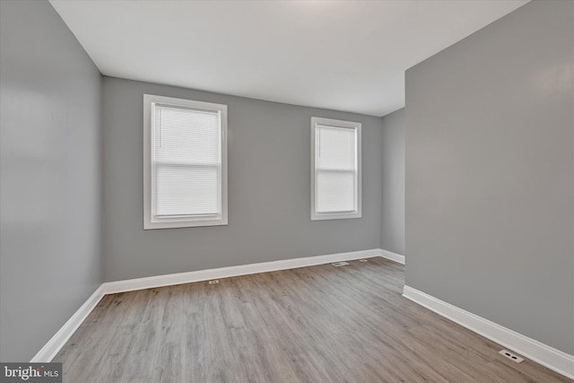 empty room with wood finished floors and baseboards