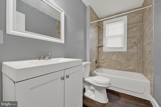 full bathroom featuring toilet, wood finished floors, vanity, and shower / bath combination