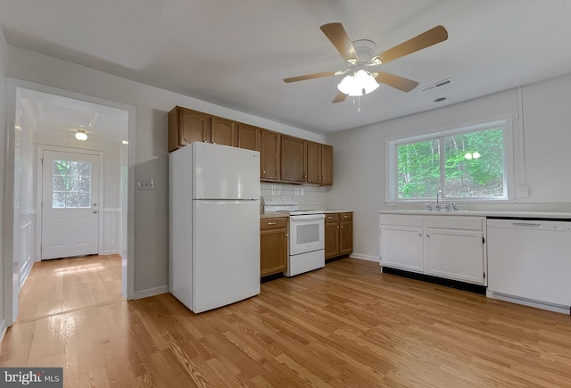 42190 Ridge Rd, Mechanicsville, MD 20659 - kitchen featuring white appliances, a sink, light wood finished floors, and light countertops