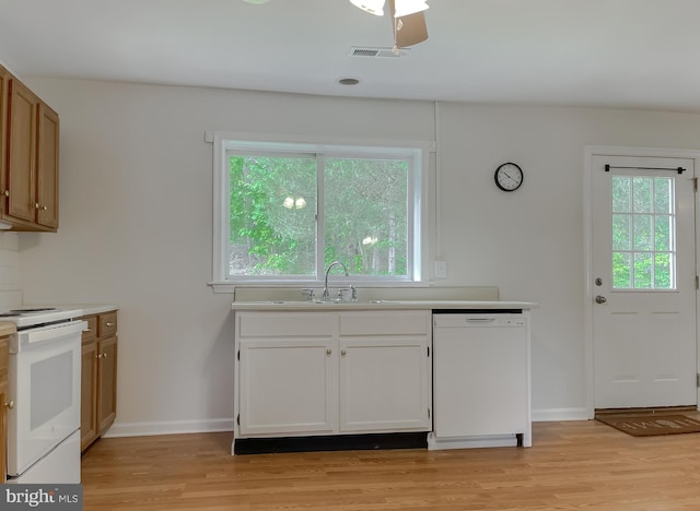 42190 Ridge Rd, Mechanicsville, MD 20659 - kitchen featuring light wood-style floors, light countertops, white appliances, and a sink