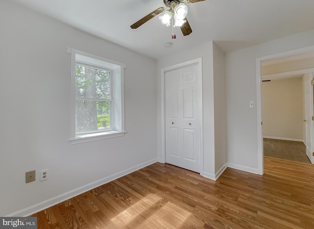 42190 Ridge Rd, Mechanicsville, MD 20659 - unfurnished bedroom featuring baseboards, a ceiling fan, a closet, and light wood-type flooring